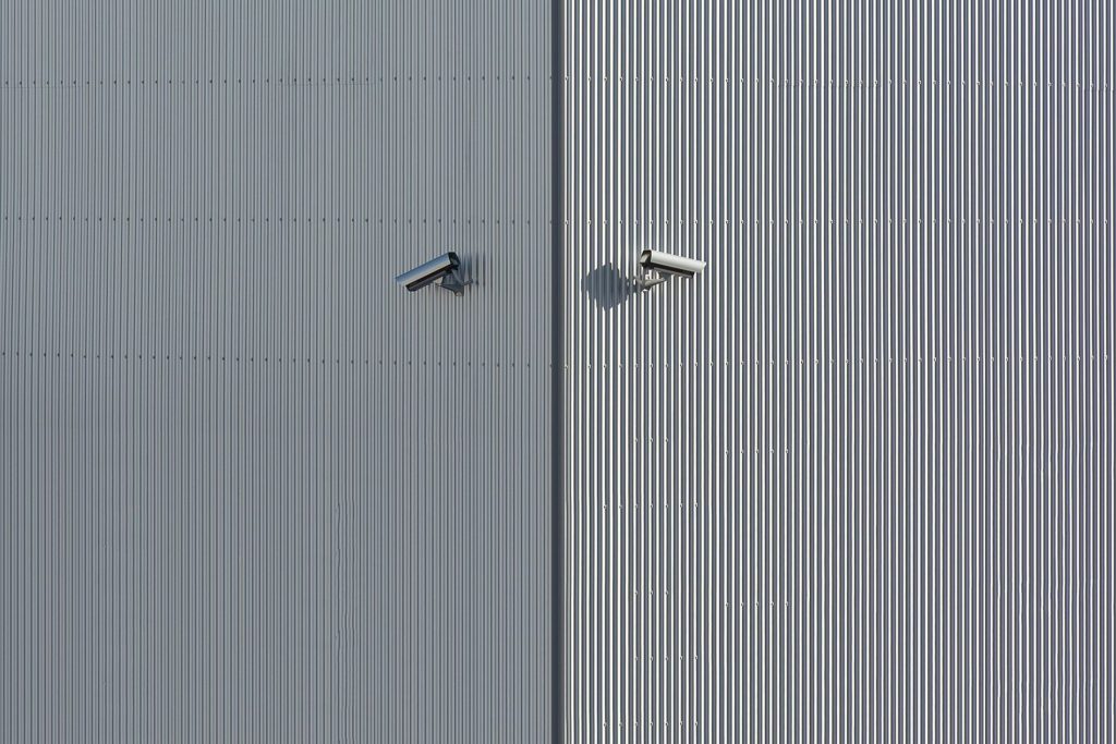 Security cameras mounted on a metal wall